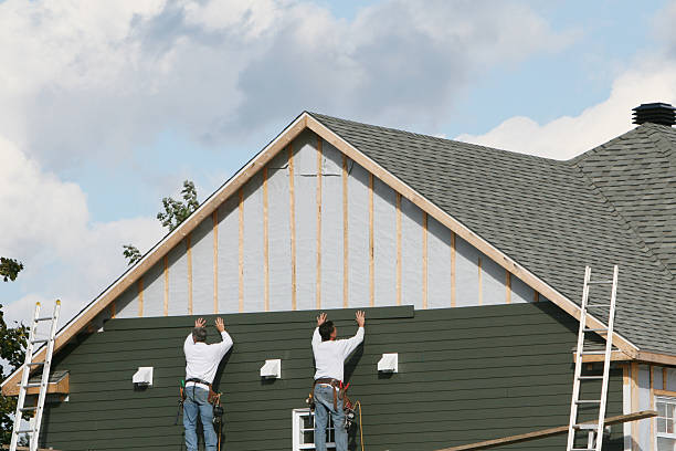 Professional Storm Damage Siding Repair technician working in Trinway, OH